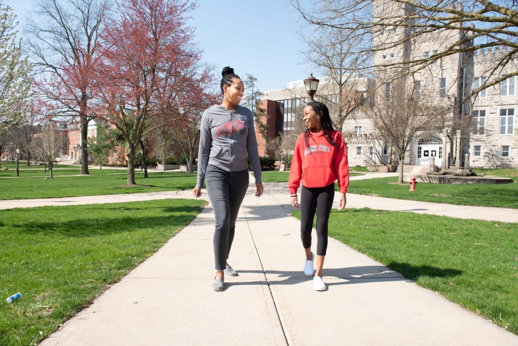 Mother and daughter walking on campus 