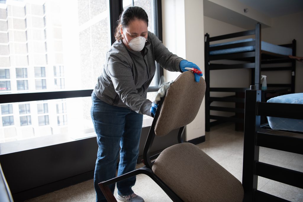Woman sanitizing chairs