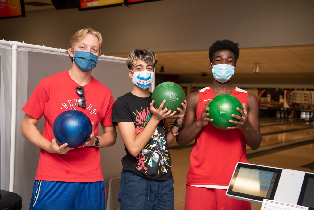 Three students pose at the Bowling and Billiards Center