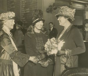 Florence and Gertrude Bohrer shaking hands