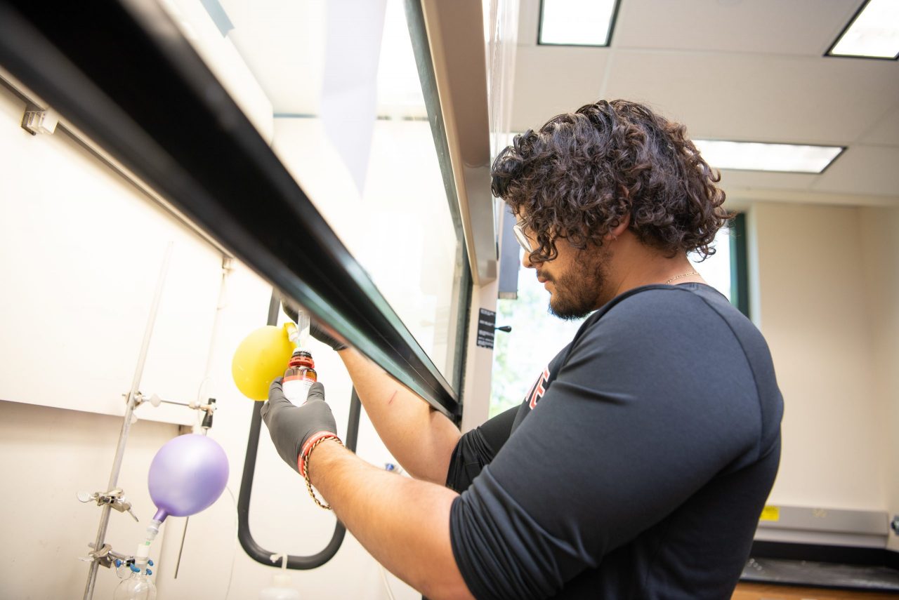 Juan Canchola working in the lab of Dr. Jonathan Mills in the Science Lab Building