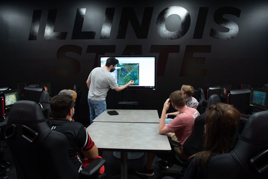 Redbird Esports players look at a touchscreen in The Vault