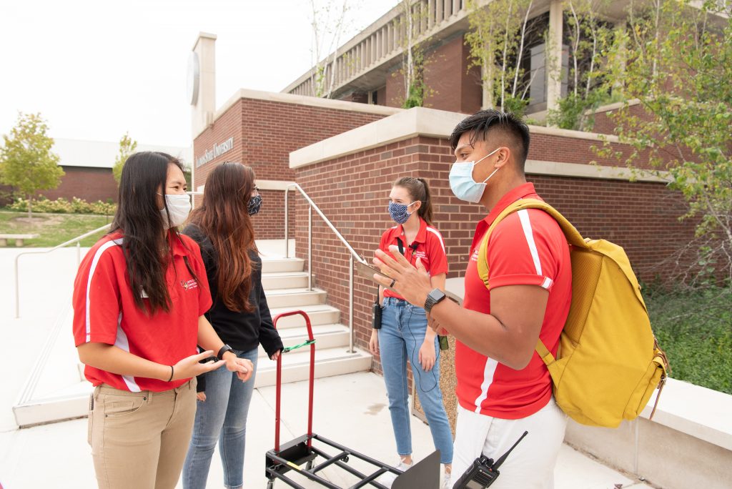 Adrian Micor checks in with the other Admissions guides to find out the majors of the students he is about to give a tour to.