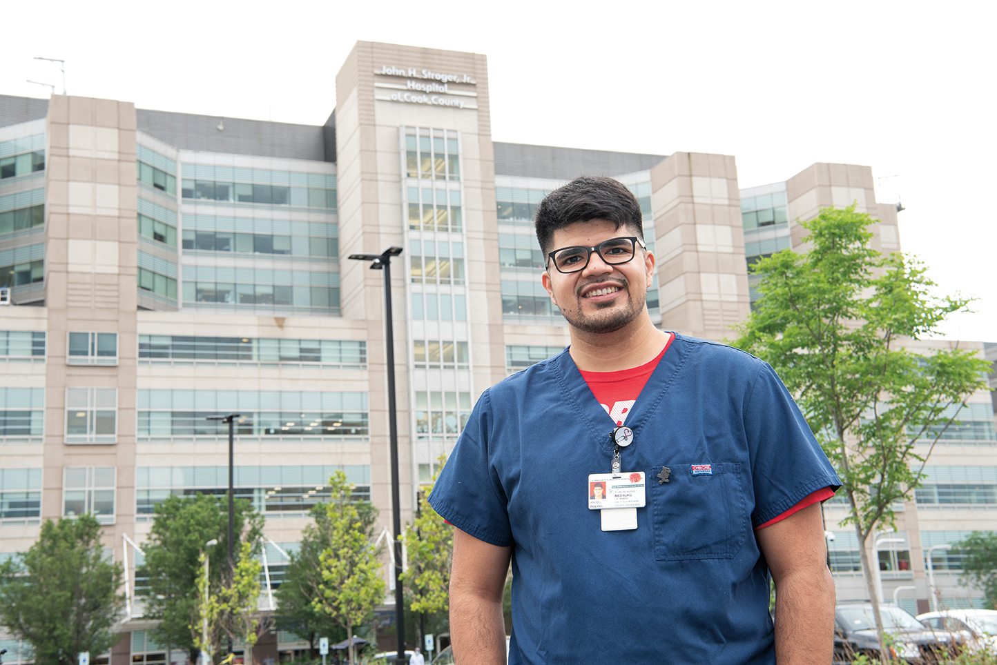 Angel Pulido standing in front of a hospital