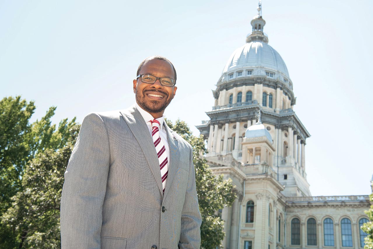 Dr. Jonathan Lackland smiles for a photo outside of the State of Illinois capitol in Springfield.