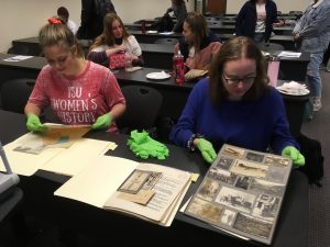 Women's History Club members examine archival items.
